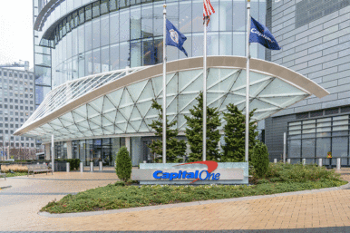 A Capital One sign in front of a glass-paneled building