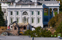 Construction workers, bottom right, atop the U.S. Treasury, watch as work continues on a largely demolished part of the East Wing of the White House on Oct. 23, 2025, before construction of a new ballroom. (AP Photo/Jacquelyn Martin)