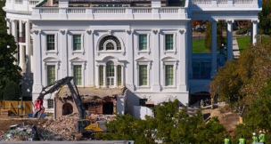 Construction workers, bottom right, atop the U.S. Treasury, watch as work continues on a largely demolished part of the East Wing of the White House on Oct. 23, 2025, before construction of a new ballroom. (AP Photo/Jacquelyn Martin)