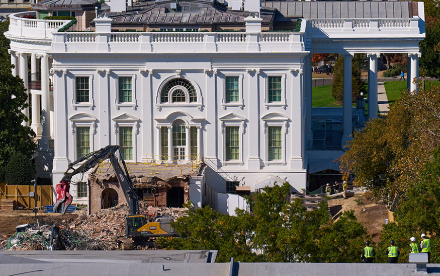 Construction workers, bottom right, atop the U.S. Treasury, watch as work continues on a largely demolished part of the East Wing of the White House on Oct. 23, 2025, before construction of a new ballroom. (AP Photo/Jacquelyn Martin)