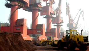 FILE PHOTO: Workers transport soil containing rare earth elements for export at a port in Lianyungang, Jiangsu province, China October 31, 2010. REUTERS/Stringer/File Photo