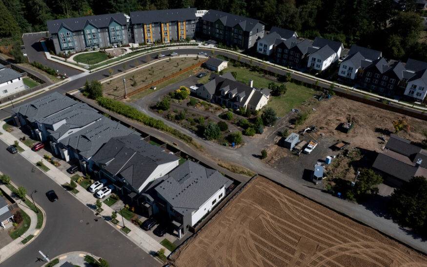 FILE - New construction homes and apartments are seen surrounding an older home on Friday, July 11, 2025, in Happy Valley, Ore. (AP Photo/Jenny Kane, File)