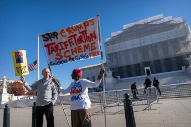 Protestors stand oustside the Supreme Court on Wednesday, Nov. 5, 2025, in Washington. (AP Photo/Mark Schiefelbein)