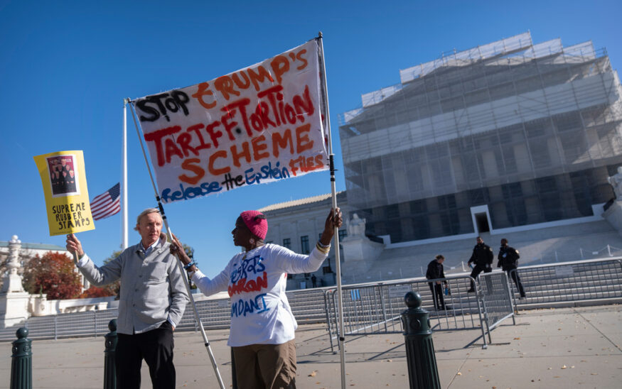 Protestors stand oustside the Supreme Court on Wednesday, Nov. 5, 2025, in Washington. (AP Photo/Mark Schiefelbein)