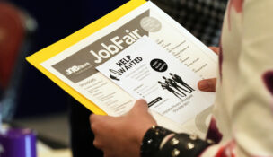 FILE - A job seeker waits to talk to a recruiter at a job fair Aug. 28, 2025, in Sunrise, Fla. (AP Photo/Marta Lavandier, File)