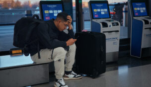 A passenger flying with Arajet to Santo Domingo waits to check in at Newark Liberty International Airport on Friday, Nov. 7, 2025 in Newark, N.J. (AP Photo/Andres Kudacki)
