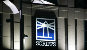FILE - Floodlights light up the E.W. Scripps logo on the company's headquarters in Cincinnati, Jan. 31, 2006. (AP Photo/Al Behrman, File)
