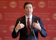 FILE - FBI Director James Comey gestures as he speaks on cyber security at the first Boston Conference of Cyber Security at Boston College, March 8, 2017, in Boston. (AP Photo/Stephan Savoia, File)
