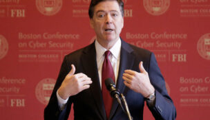 FILE - FBI Director James Comey gestures as he speaks on cyber security at the first Boston Conference of Cyber Security at Boston College, March 8, 2017, in Boston. (AP Photo/Stephan Savoia, File)