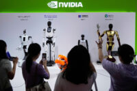 FILE - Visitors give commands to robots at Nvidia's booth during the China International Supply Chain Expo at the China International Exhibition Center in Beijing, China, July 18, 2025. (AP Photo/Mahesh Kumar A., File)