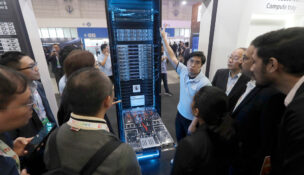 Visitors listen to the introduction of NVIDIA GB300 NVL72 AI server during the Hon Hai Tech Day (HHTD 25) at the Nangang Exhibition Center in Taipei, Taiwan, Friday, Nov. 21, 2025. (AP Photo/Chiang Ying-ying)