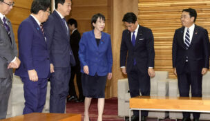 Japan's Prime Minister Sanae Takaichi, center, arrives for a cabinet meeting at her office in Tokyo Friday, Nov. 21, 2025. (Yuki Sato/Kyodo News via AP)