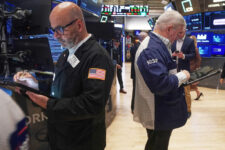 Traders Fred Demarco, left, and Edward McCarthy work on the floor of the New York Stock Exchange, Monday, Nov. 24, 2025. (AP Photo/Richard Drew)