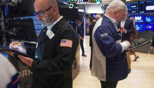 Traders Fred Demarco, left, and Edward McCarthy work on the floor of the New York Stock Exchange, Monday, Nov. 24, 2025. (AP Photo/Richard Drew)