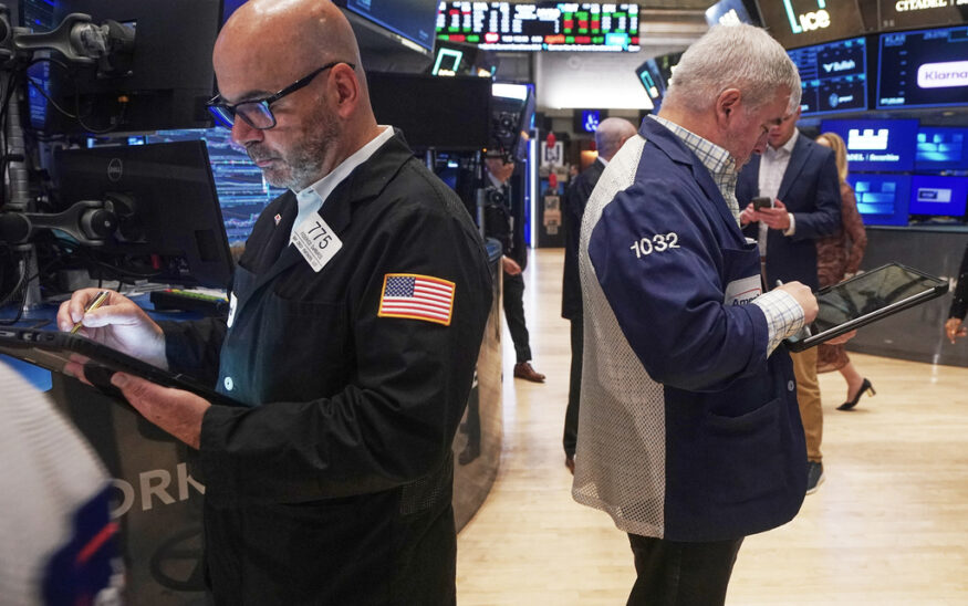 Traders Fred Demarco, left, and Edward McCarthy work on the floor of the New York Stock Exchange, Monday, Nov. 24, 2025. (AP Photo/Richard Drew)