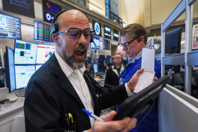 Options trader Steven Rodriguez, left, works on the floor of the New York Stock Exchange, Monday, Nov. 24, 2025. (AP Photo/Richard Drew)