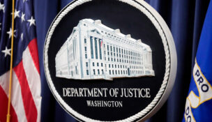 FILE - The logo for the Justice Department is seen before a news conference at the Department of Justice on Aug. 23, 2024, in Washington. (AP Photo/Mark Schiefelbein, File)