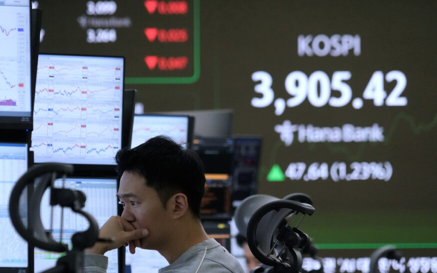 A currency trader watches monitors near a screen showing the Korea Composite Stock Price Index (KOSPI) at the foreign exchange dealing room of the Hana Bank headquarters in Seoul, South Korea, Wednesday, Nov. 26, 2025. (AP Photo/Ahn Young-joon)