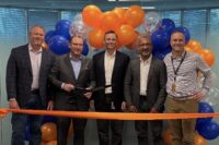 Xcelerate Solutions' leadership team cut the ribbon on its new headquarters space on Tuesday. From left: Mike Brokaw, Mark Drever, David Kapusta, Vivek Malhotra and Doug Kollme. Photo courtesy Fairfax County Economic Development Authority.