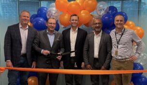 Xcelerate Solutions' leadership team cut the ribbon on its new headquarters space on Tuesday. From left: Mike Brokaw, Mark Drever, David Kapusta, Vivek Malhotra and Doug Kollme. Photo courtesy Fairfax County Economic Development Authority.