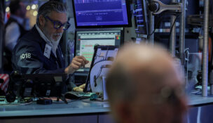 A trader works on the floor at the New York Stock Exchange (NYSE) in New York City, U.S., December 11, 2025. REUTERS/Jeenah Moon