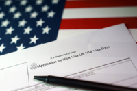 A U.S. flag and a U.S. H-1B Visa application form are seen in this illustration taken, September 22, 2025. REUTERS/Dado Ruvic/Illustration