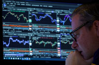 FILE PHOTO: A specialist trader works inside a booth on the floor at the New York Stock Exchange (NYSE) in New York City, U.S., November 19, 2025. REUTERS/Brendan McDermid//File Photo