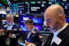 FILE PHOTO: Traders work on the floor, as a screen displays The Goldman Sachs logo and trading information, at the New York Stock Exchange (NYSE) in New York City, U.S., April 14, 2025. REUTERS/Brendan McDermid/File Photo