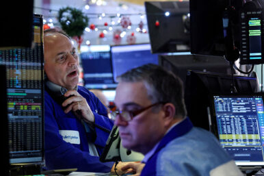 FILE PHOTO: Traders work on the floor at the New York Stock Exchange (NYSE) in New York City, U.S., December 17, 2025. REUTERS/Brendan McDermid/File Photo