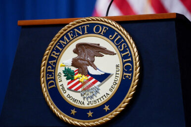 FILE PHOTO: The seal of the U.S. Justice Department is seen on the podium in the Department's headquarters briefing room before a news conference with the Attorney General in Washington, January 24, 2023. REUTERS/Kevin Lamarque/File Photo