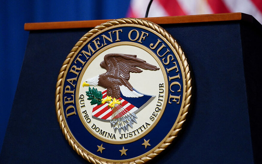 FILE PHOTO: The seal of the U.S. Justice Department is seen on the podium in the Department's headquarters briefing room before a news conference with the Attorney General in Washington, January 24, 2023. REUTERS/Kevin Lamarque/File Photo