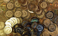 FILE - Bitcoin tokens are seen on April 3, 2013, in Sandy, Utah. (AP Photo/Rick Bowmer, File)