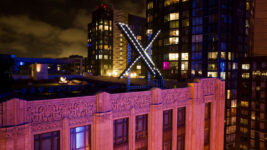 FILE - Workers install lighting on an "X" sign atop the company headquarters in downtown San Francisco, July 28, 2023. (AP Photo/Noah Berger, File)