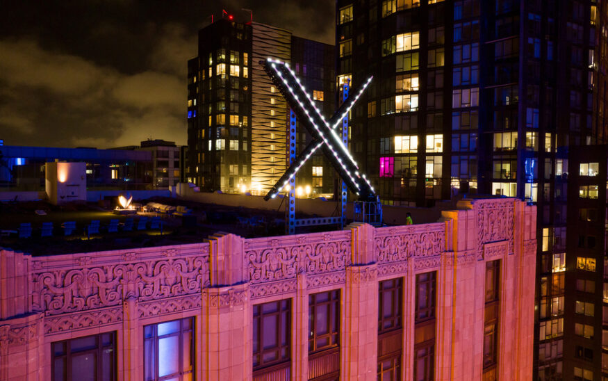 FILE - Workers install lighting on an "X" sign atop the company headquarters in downtown San Francisco, July 28, 2023. (AP Photo/Noah Berger, File)