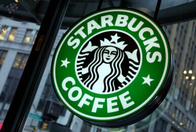FILE - This Dec. 20, 2010 file photo shows signage at a Starbucks store in New York. (AP Photo/Richard Drew, File)