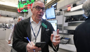 Options trader Joseph D'Arrigo works on the floor of the New York Stock Exchange, Tuesday, Dec. 2, 2025. (AP Photo/Richard Drew)