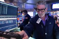 Trader John Romolo works on the floor of the New York Stock Exchange, Tuesday, Dec. 2, 2025. (AP Photo/Richard Drew)