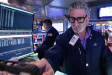 Trader John Romolo works on the floor of the New York Stock Exchange, Tuesday, Dec. 2, 2025. (AP Photo/Richard Drew)