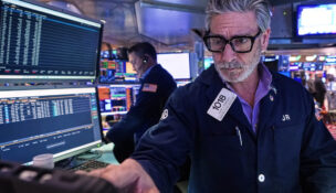 Trader John Romolo works on the floor of the New York Stock Exchange, Tuesday, Dec. 2, 2025. (AP Photo/Richard Drew)