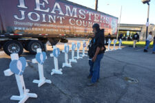 FILE - Allen Wilson, right, hugs an attendee after they wrote on crosses for victims during a vigil Thursday, Nov. 6, 2025, in Louisville, Ky., after a UPS plane crashed at Louisville Muhammad Ali International Airport. (AP Photo/Darron Cummings, File)