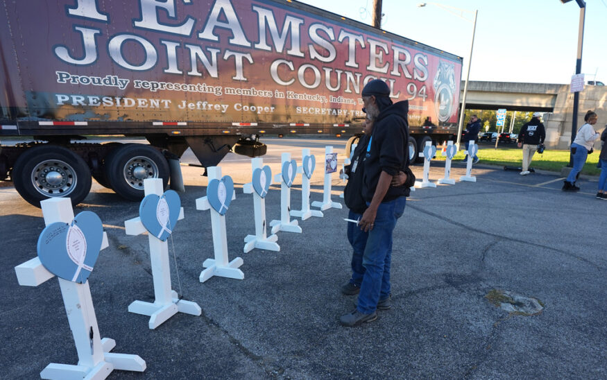 FILE - Allen Wilson, right, hugs an attendee after they wrote on crosses for victims during a vigil Thursday, Nov. 6, 2025, in Louisville, Ky., after a UPS plane crashed at Louisville Muhammad Ali International Airport. (AP Photo/Darron Cummings, File)