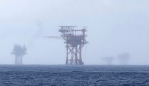 FILE - Oil platforms are visible through the haze near the Flower Garden Banks National Marine Sanctuary in the Gulf of Mexico, off the coast of Galveston, Texas, Saturday, Sept. 16, 2023. (AP Photo/LM Otero, File)