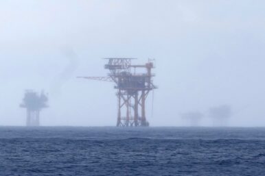 FILE - Oil platforms are visible through the haze near the Flower Garden Banks National Marine Sanctuary in the Gulf of Mexico, off the coast of Galveston, Texas, Saturday, Sept. 16, 2023. (AP Photo/LM Otero, File)