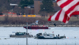FILE - A diving team and police boat is seen near a wreckage site in the Potomac River, from Ronald Reagan Washington National Airport, Jan. 30, 2025, in Arlington, Va. (AP Photo/Jose Luis Magana, File)