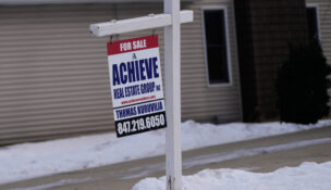 A "For Sale" sign is displayed in front of a home in Prospect Heights, Ill., Monday, Dec. 15, 2025. (AP Photo/Nam Y. Huh)