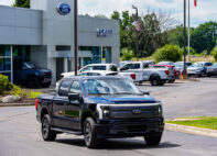 Woody Gontina, 49, Royal Oak, takes delivery of his new Ford F-150 Lightning that he purchased from New Car Salesman Liam Belill, 28, of Flushing, Mich. at Szott Ford dealership in Holly, Mich. on Thursday, Aug. 8, 2024.