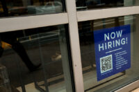 An employee hiring sign with a QR code is seen in a window of a business in Arlington, Virginia, U.S., April 7, 2023. REUTERS/Elizabeth Frantz/File Photo
