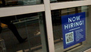 An employee hiring sign with a QR code is seen in a window of a business in Arlington, Virginia, U.S., April 7, 2023. REUTERS/Elizabeth Frantz/File Photo