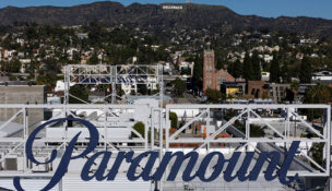 FILE PHOTO: A drone view shows a sign for Paramount in front of the Hollywood sign in Los Angeles, California, December 8, 2025. REUTERS/Daniel Cole/File Photo