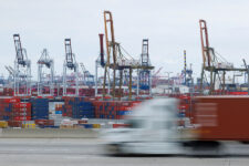 A semi-truck drives past Chinese shipping containers at the Port of Los Angeles in Wilmington, California, U.S., November 5, 2025. REUTERS/Mike Blake